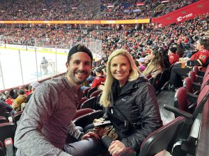 Elizabeth and her husband at a hockey game won through a sweepstakes